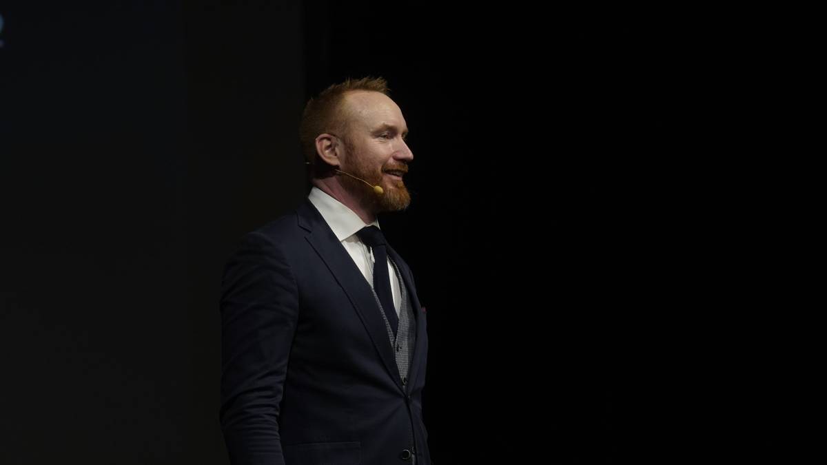 David JP Phillips on a dark stage